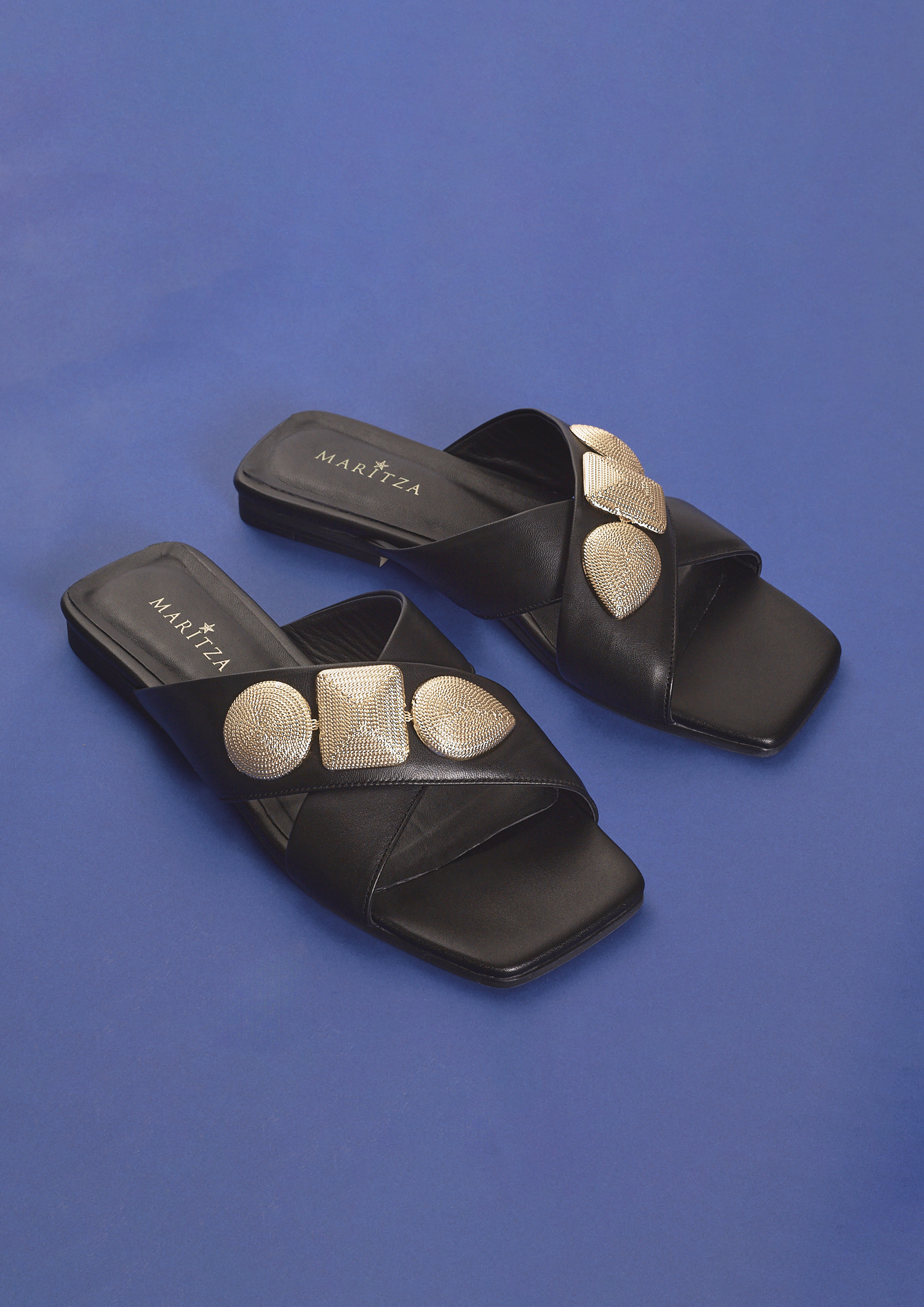 MARITZA MZ-128 black leather cross-strap slides with gold medallion ornaments
